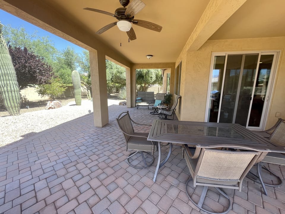 Outdoor patio with table, sitting area and grill.  1/3 of an acre