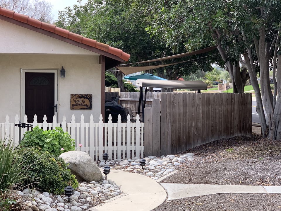 Bungalow fenced Shaded Patio on Right.