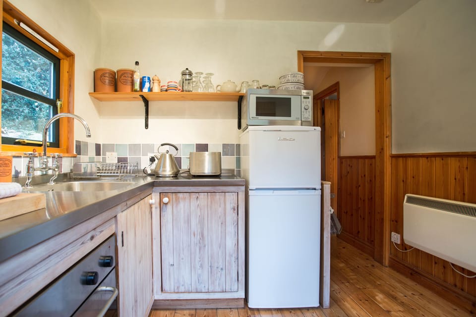 Kitchen - stainless steel worktop & oven, ceramic hob, microwave, fridge-freezer