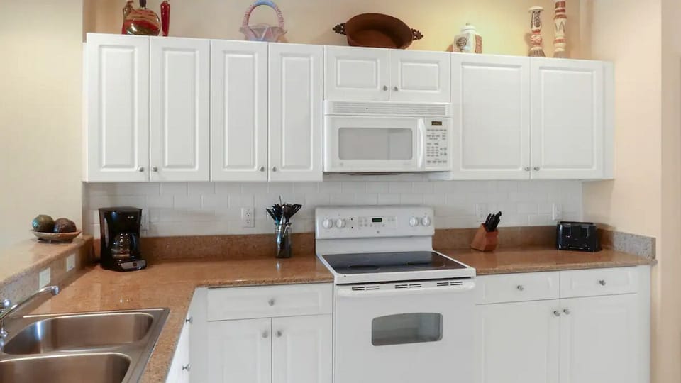 Well equipped kitchen with granite counter tops.