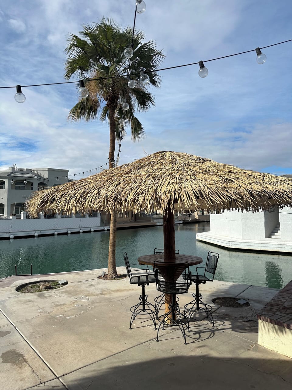 Patio with palapa with main canal in front of house and side canal