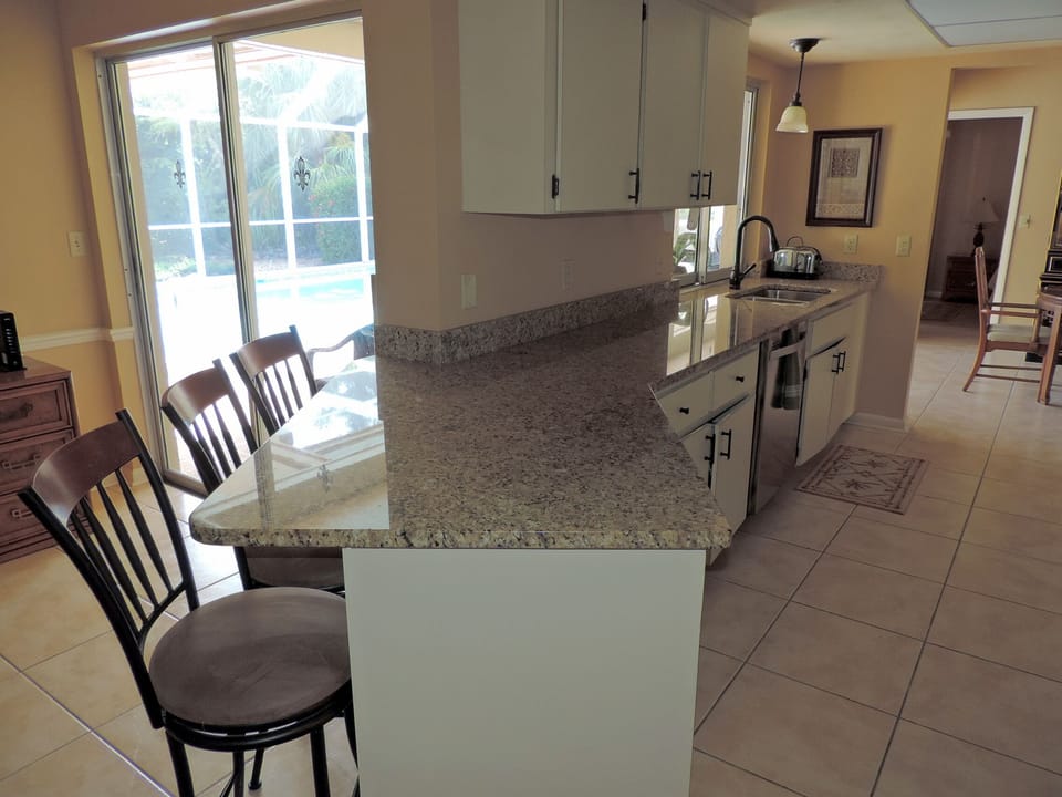 Kitchen - granite counter tops, bar seating, fully stocked with cooking utensils