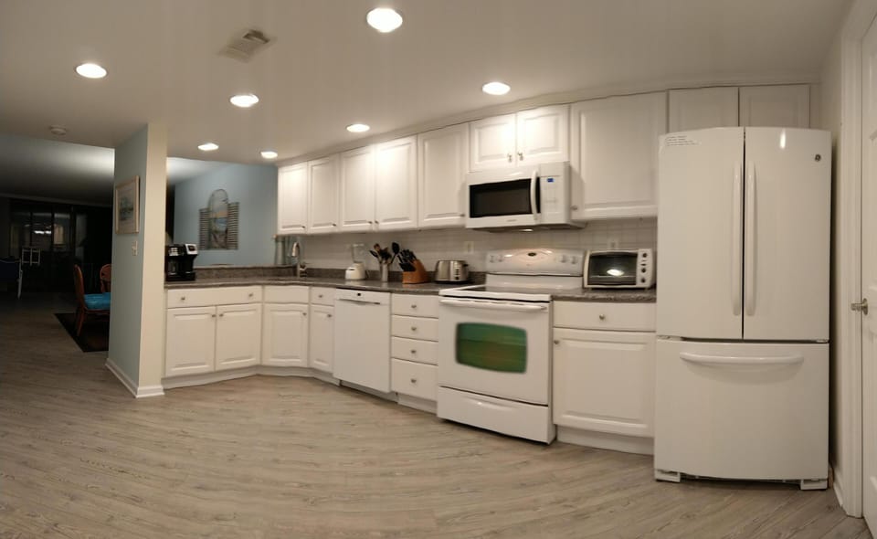 Open  Kitchen with Quartz Counter Tops. French door refrigerator.