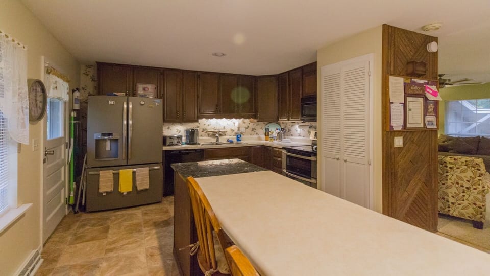 View from dining area. Large fridge, double-oven stove, pantry, etc.