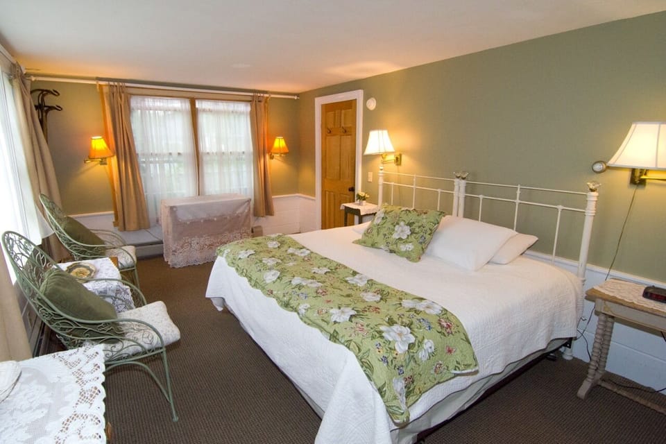 Garden Suite. A first floor favorite  for its space, light, and privacy. Includes a private entrance, king bed, bath with tub/shower, TV, large east and south-facing windows with a pastoral view of the gardens between our two buildings. Deck to the garden. Large private sitting room with exit door to the front porch.  Sleeps Two King Size Bed