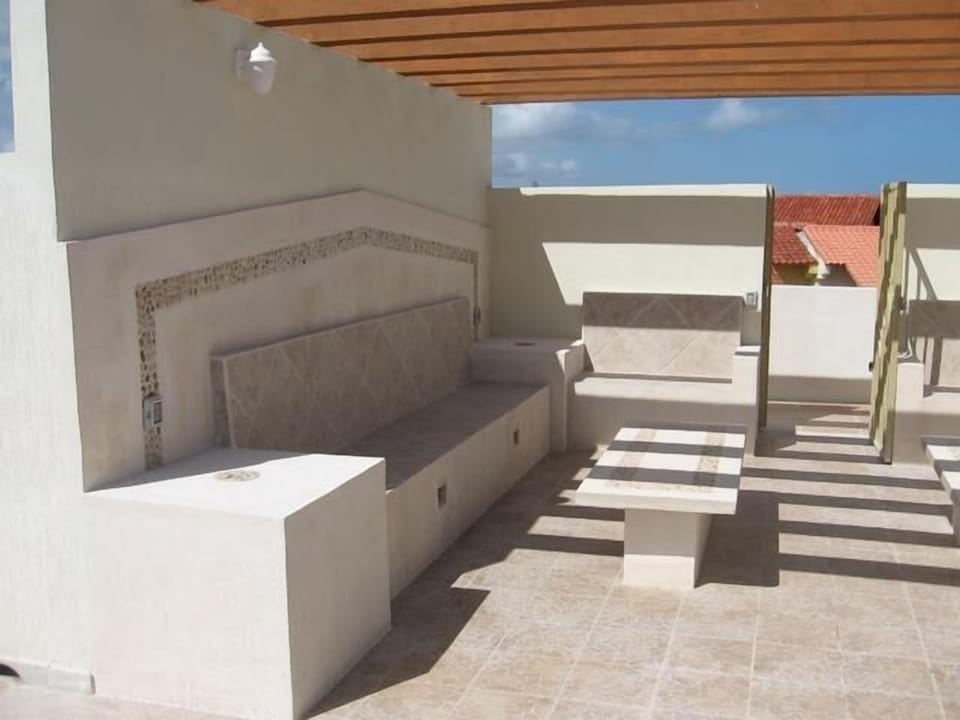 Left side of the seating area on the Private Rooftop Patio with night lighting.