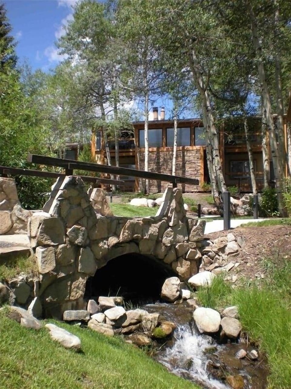 Ski bridge to slope, view facing unit and Willows open grassy area.