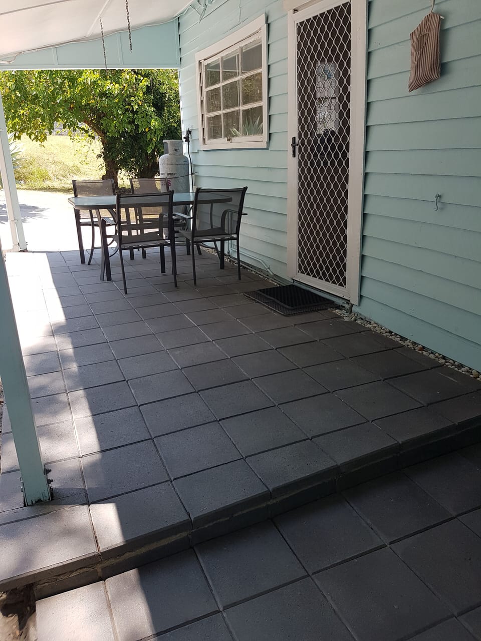 Rear patio outdoor dining with adjacent bbq