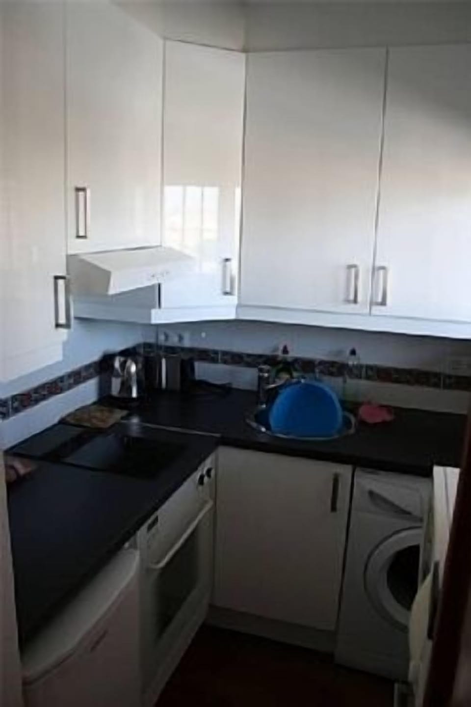 Fitted kitchen with full oven, hob, microwave, fridge and washing machine