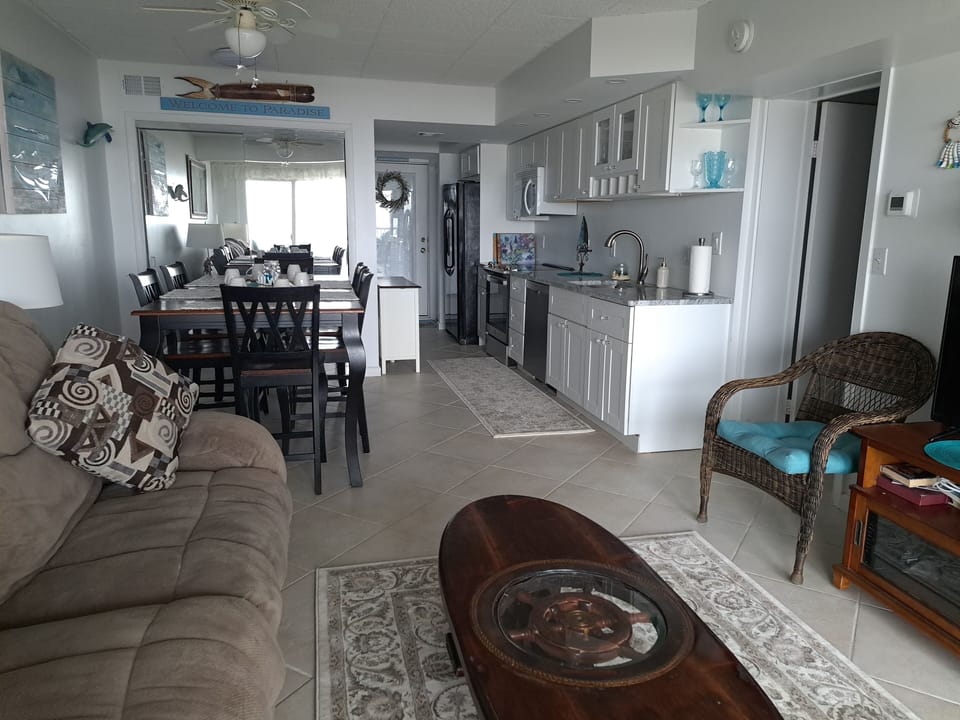 Main room with family area, dining area, and full kitchen