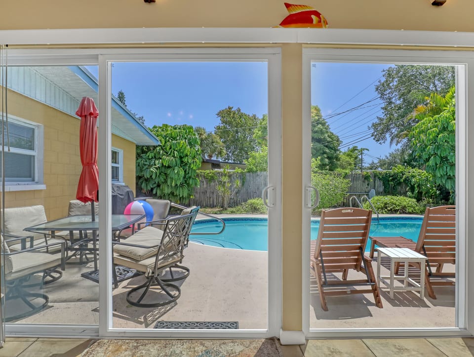 view to pool from living room couch