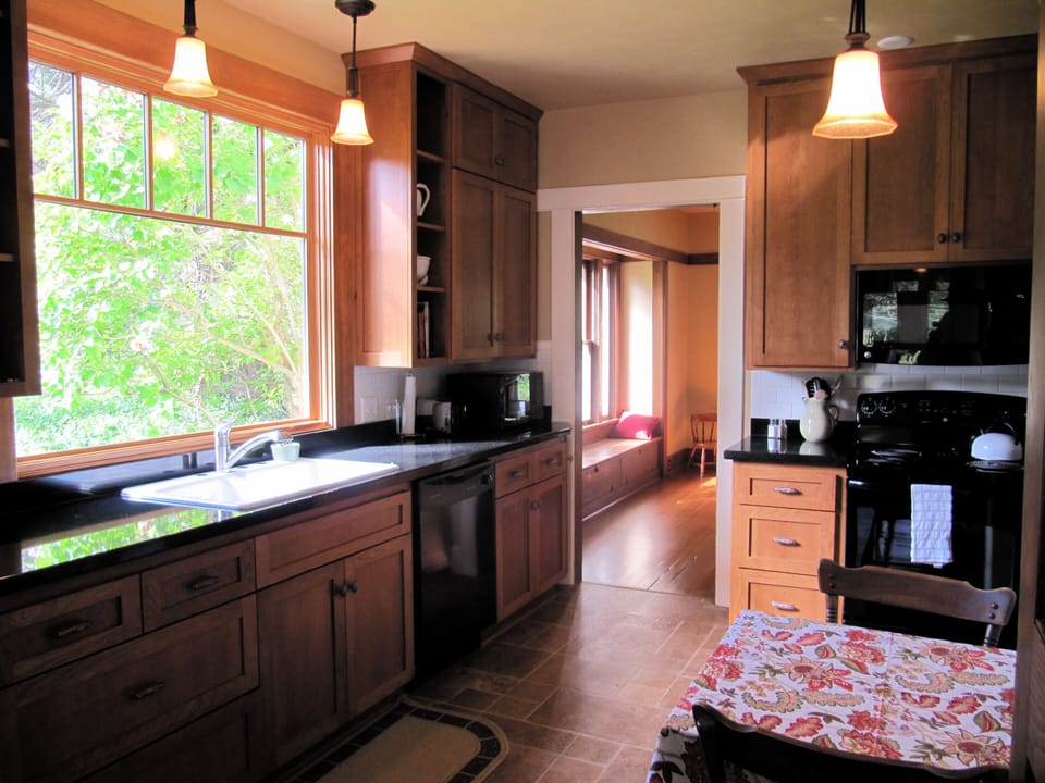 Sunny, country kitchen, granite countertops and lovely view from picture window