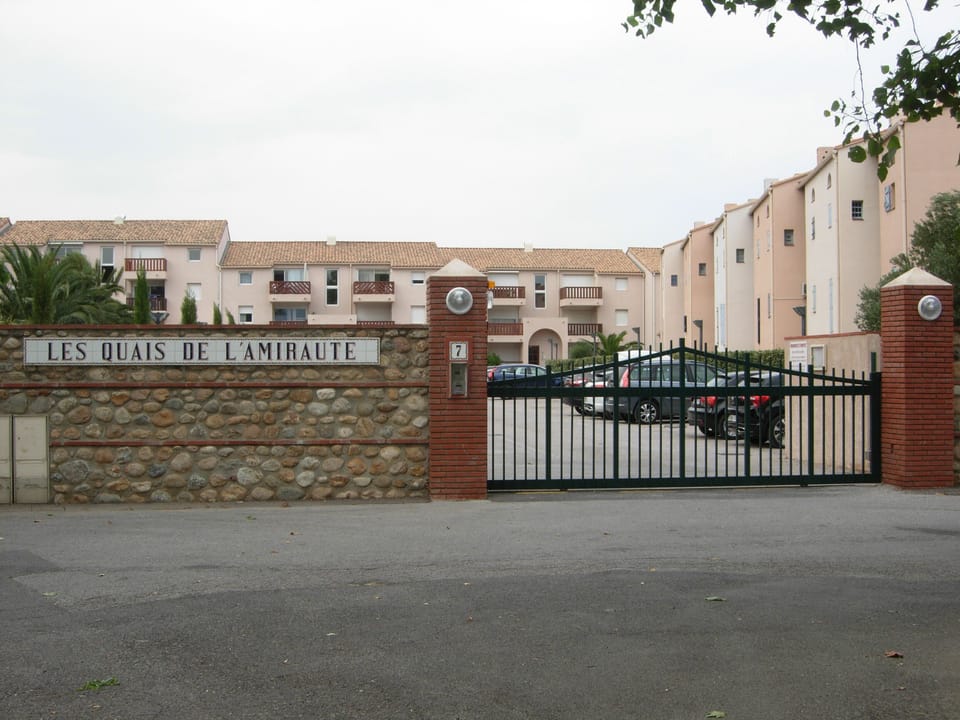 Gate Entrance to car park showing key pad on wall. 
