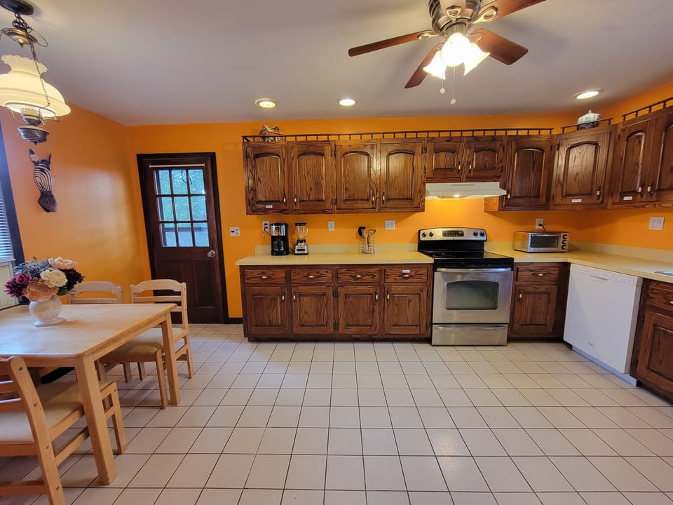 Spacious kitchen stocked with all the appliances, dishes, and utensils you need