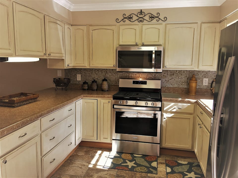 New stainless appliances. Cream glazed cabinets. 