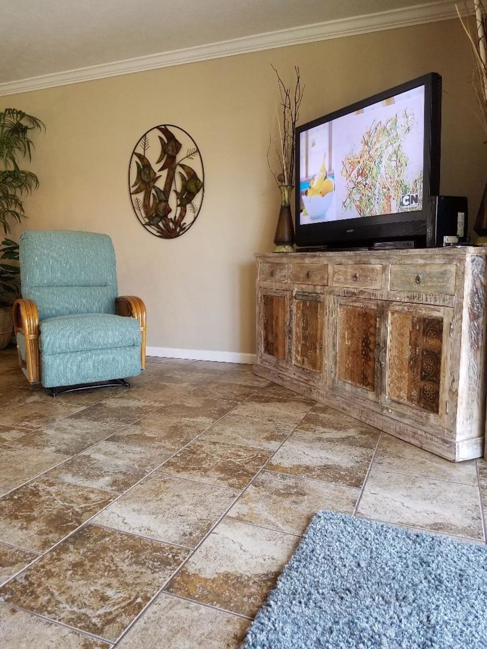 Tile throughout the downstairs with large flat screen TV.