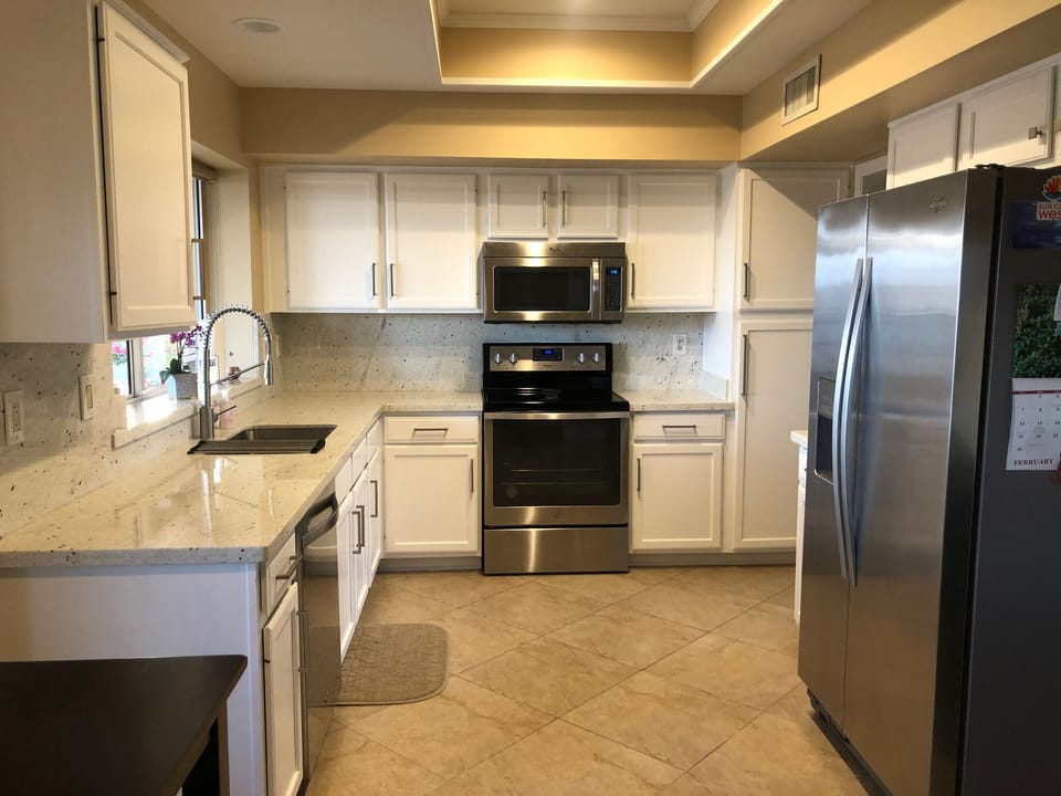 Fully stocked kitchen with granite and stainless appliances