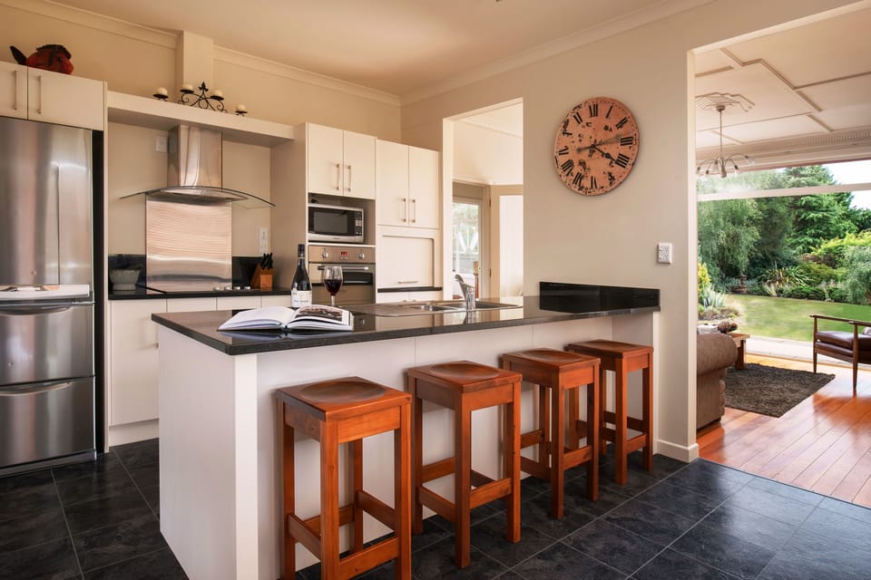 A fully equipped modern kitchen featuring granite benchtops.