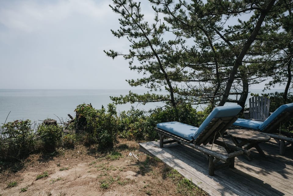 Sun chairs on the Beach Cottage deck overlooking the bay