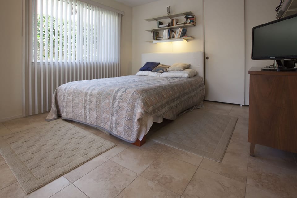 Second bedroom with queen sized bed and television