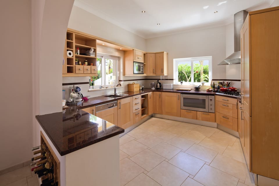 kitchen leading to dinning room and outside area downstairs
