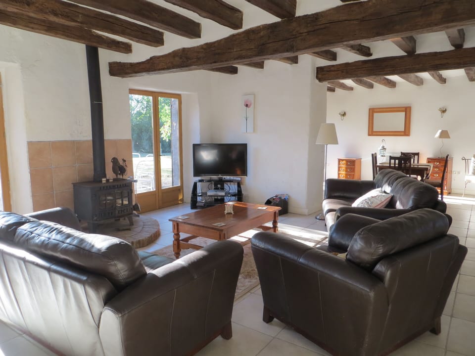 Beamed and spacious lounge with leather sofas, Plasma TV and log burning fire.