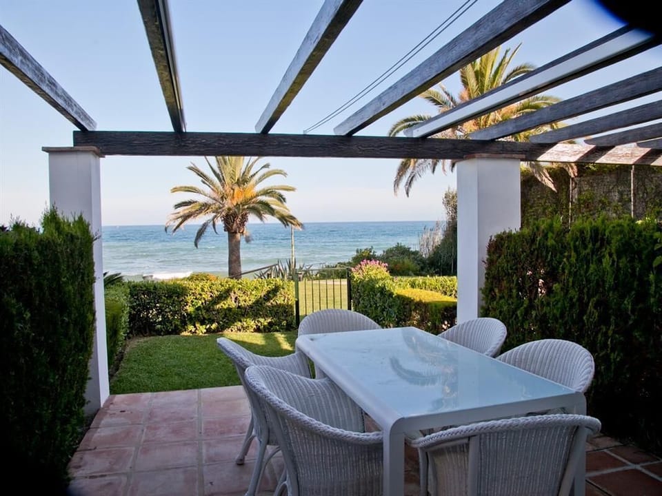 Outdoor dining area for six guests with views to the sea