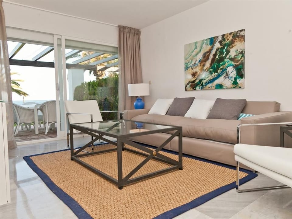 Modern and bright lounge with comfortable seating and terrace access