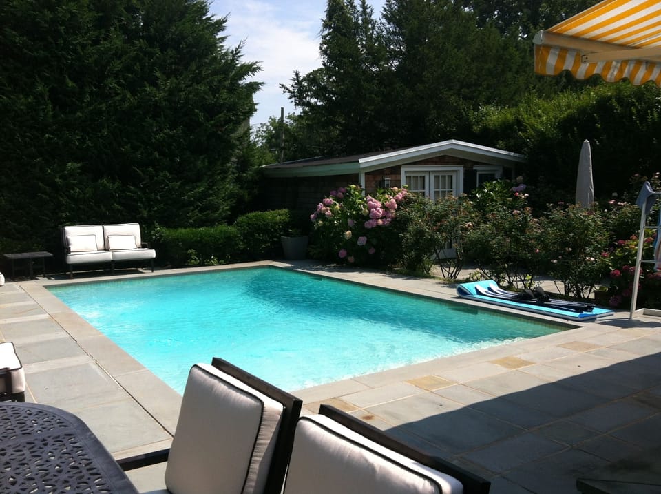 The pool and a cabana in the back of the yard