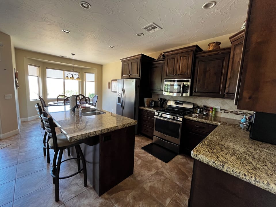 Kitchen and pantry is well stocked with coffee maker and all cooking supplies