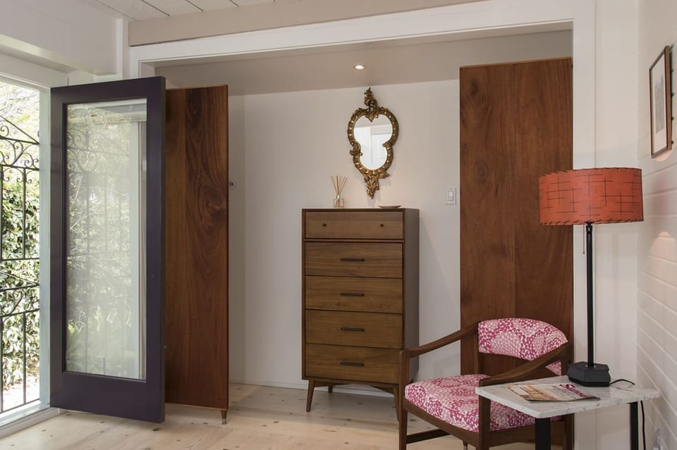 Spacious closet with West Elm dresser, vintage chair and lamp