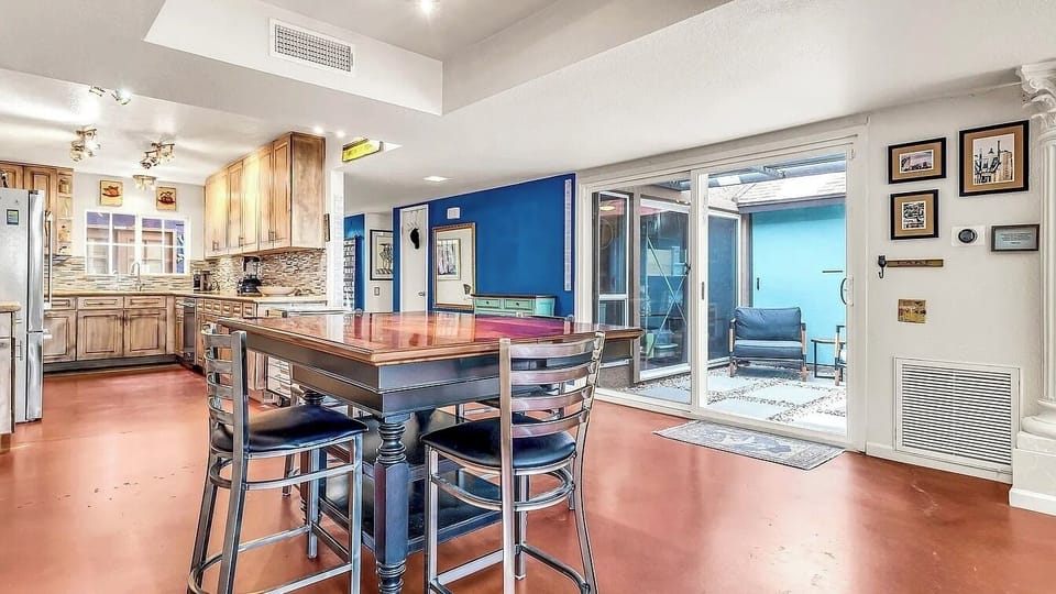 Looking toward the entry hall is the Kitchen, gathering room and outdoor atrium.