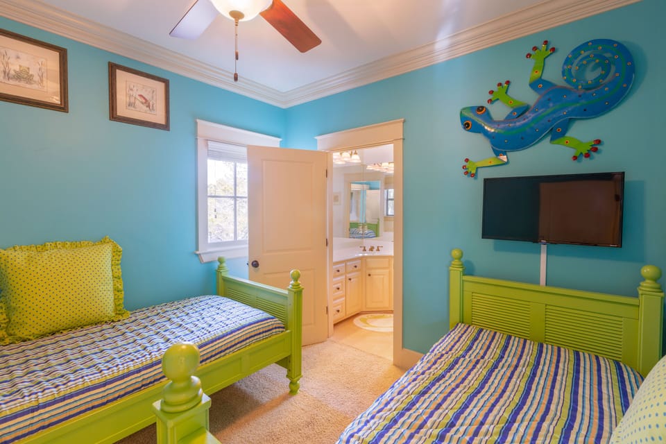 The Aqua Room Suite has 2 twin beds, adjoining full bathroom, TV, ceiling fan