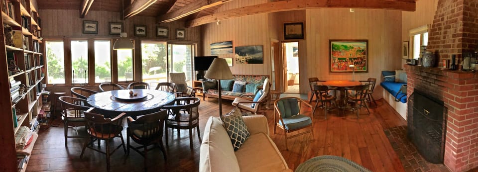South end of great room with dining area, puzzle table, and couches.