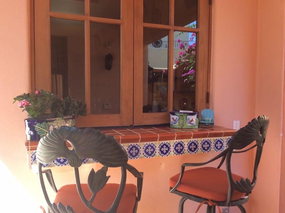 Patio sitting. Windows open out.
