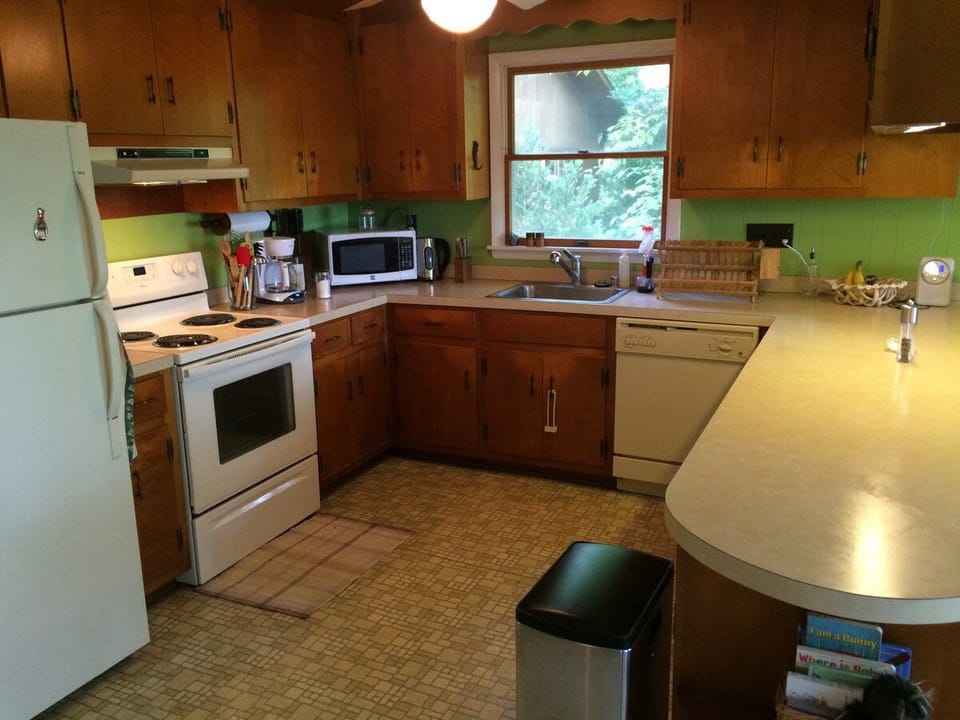 Spacious well-stocked kitchen, open to dining and living areas.