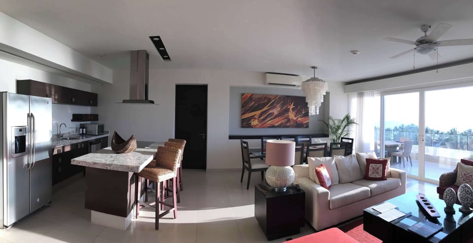Living, dining, and kitchen spaces.