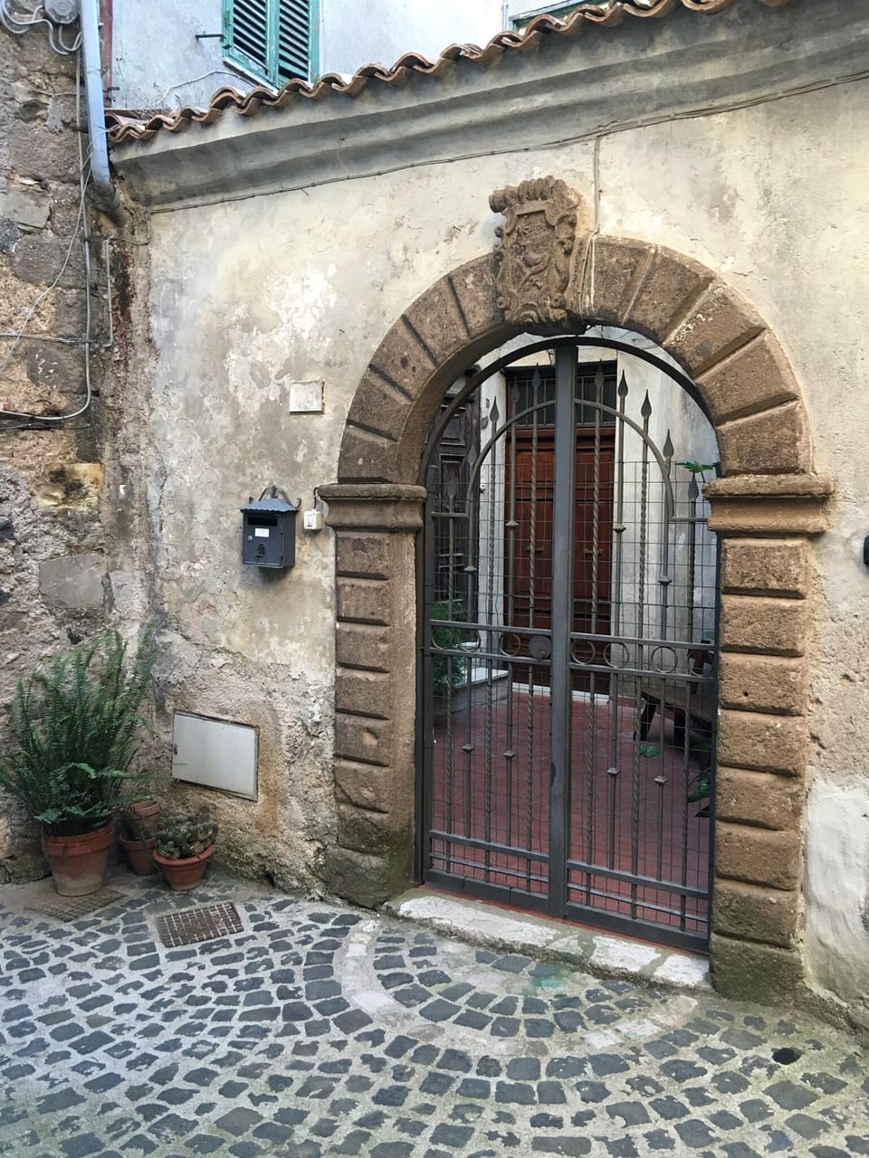 Antique gate opening on a private courtyard 