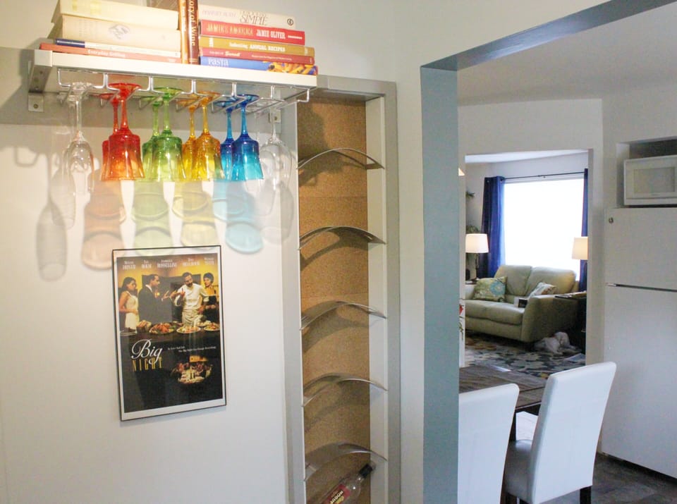Wine rack w/ courtesy bottle of local wine. Many recipe books & various glasses