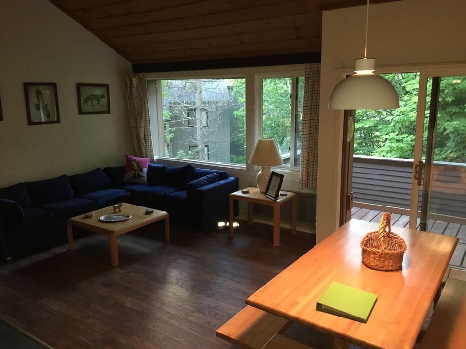 Living room with large windows which provide views of Loon Mountain.