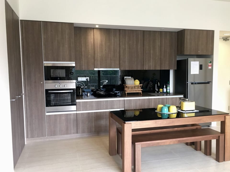 A functional kitchen with hob, hood, microwave, oven, toaster, kettle and more