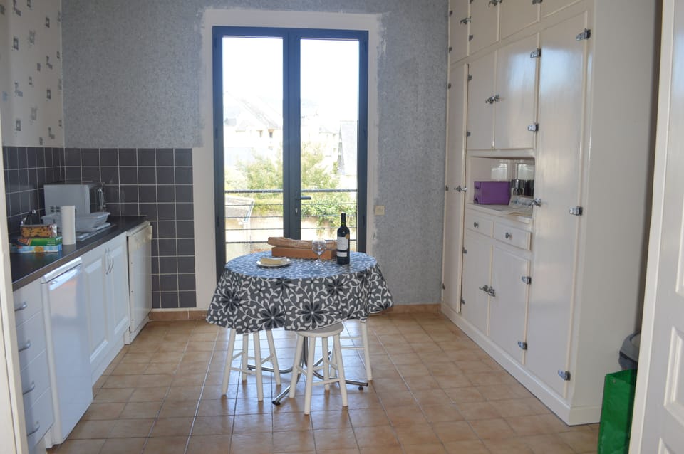 The kitchen leads out to a small balcony and steps down to the garden