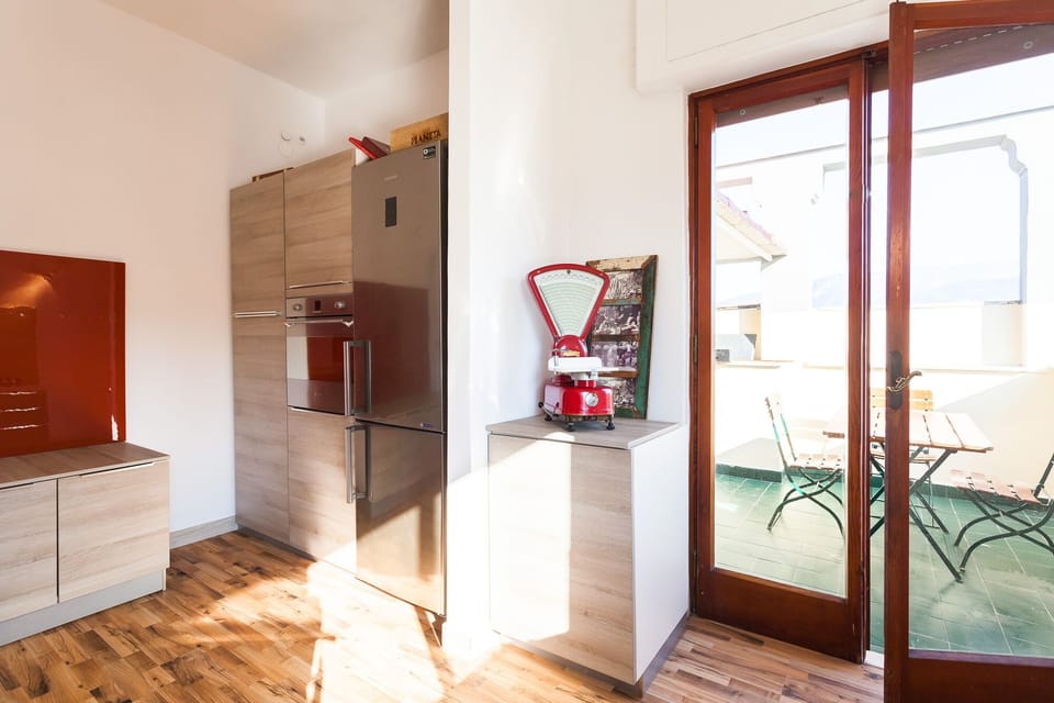 Kitchen room with patio equipped with dining table and barbecue.