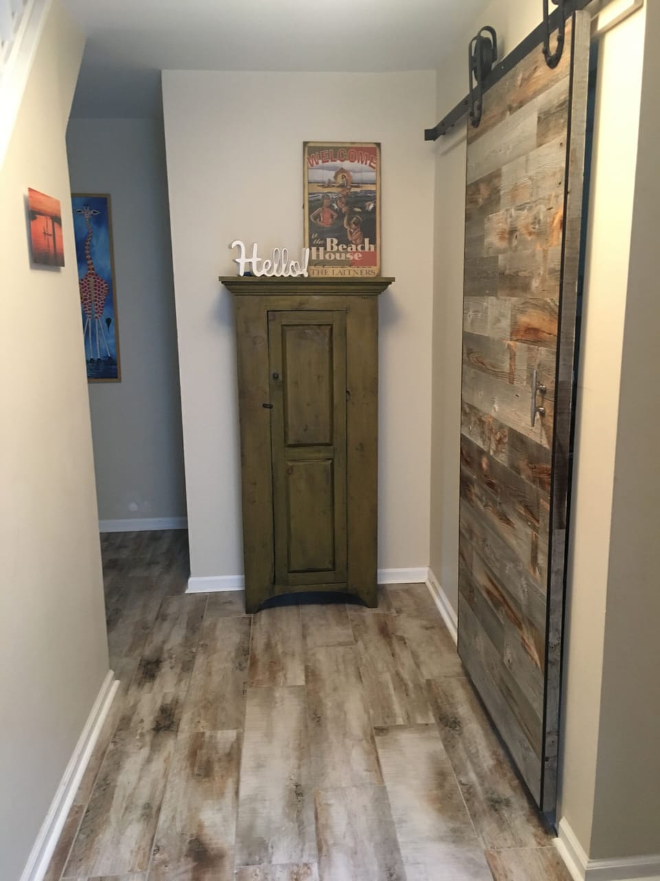 Entryway with tiled floor, barn door to laundry room 