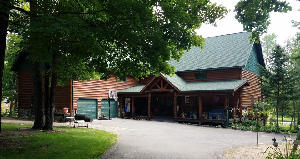 3,400 sf cabin from road.   RC Cola refrigerator on porch for food/beverages.  