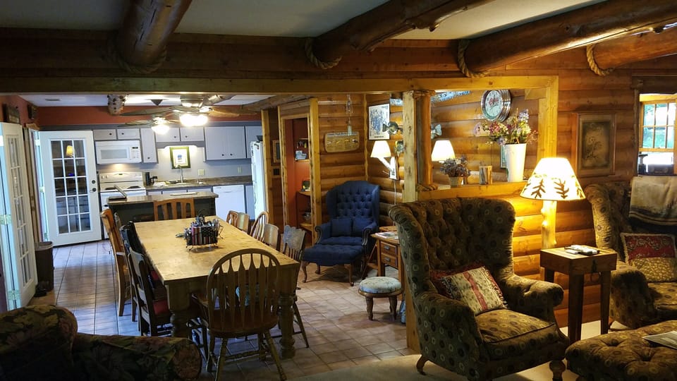 Large kitchen table and kitchen area.  Three french doors to open up to porch.  
