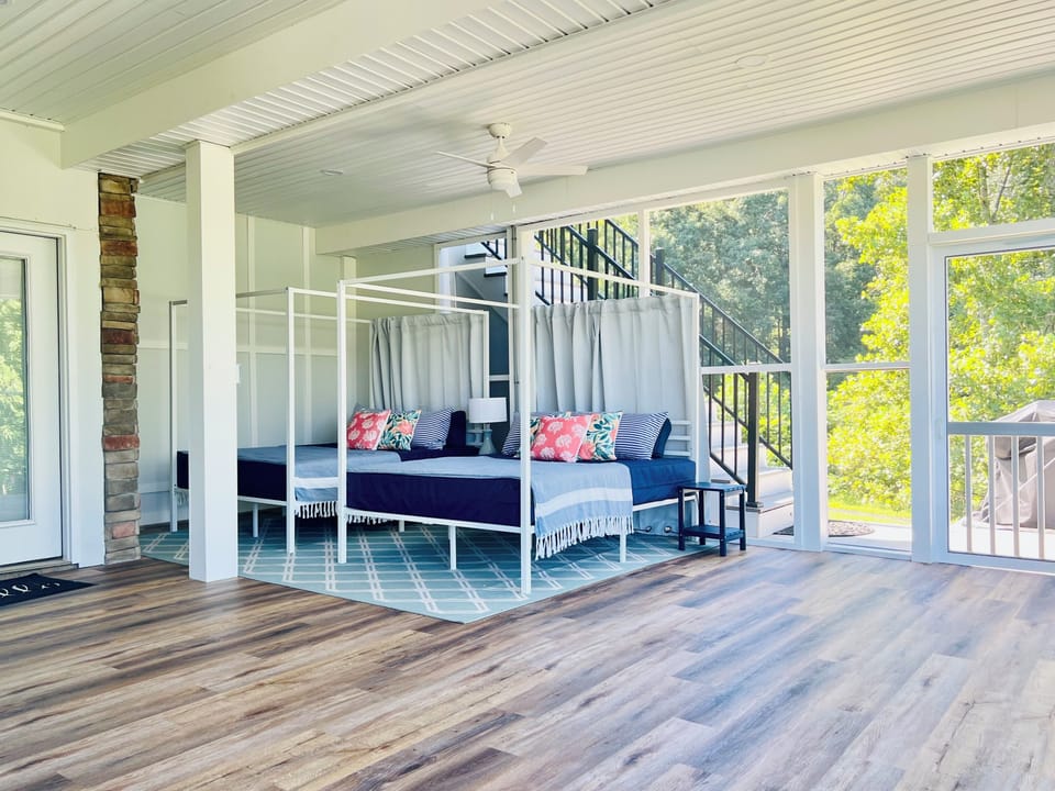 Nap, lounge, or glamp on two EXTRA queen beds on the screened sleeping porch