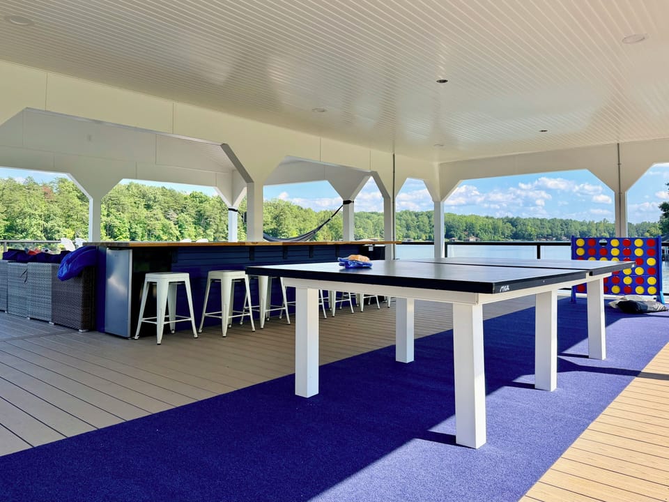 Enjoy napping hammocks, ping pong, and games on the upper deck of the boathouse