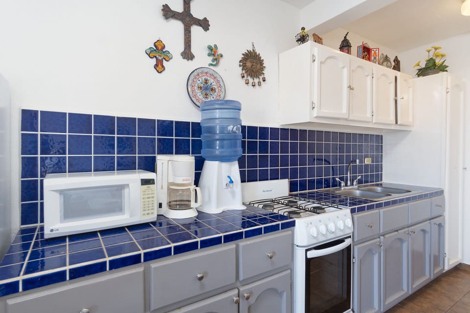 Long countertop kitchen with appliances.
