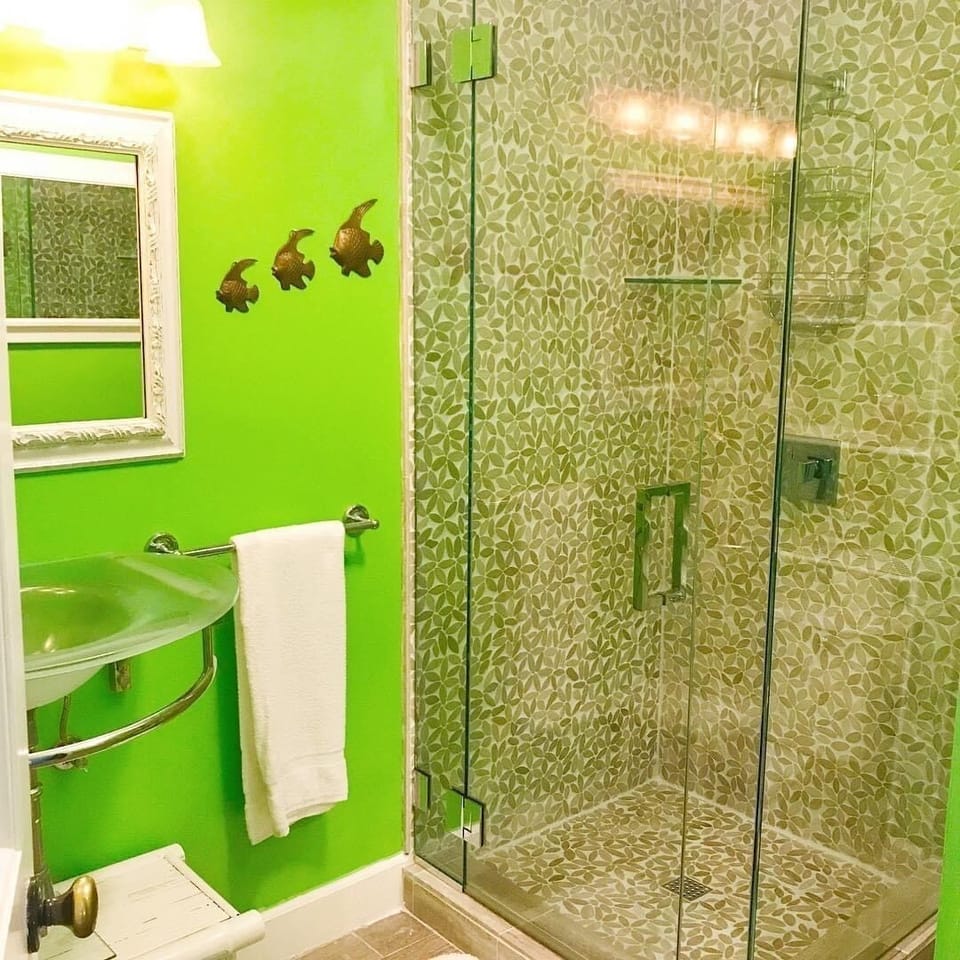 Stone tiled rain shower and a glass, freestanding sink.  
(STR#14-0231)